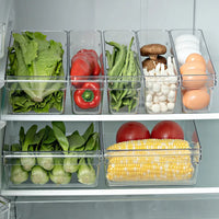 Clear refrigerator storage containers organized with fresh vegetables and eggs for efficient fridge management.