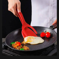 Multifunctional egg flipping shovel with food clip, effortlessly flipping eggs and vegetables in a skillet.