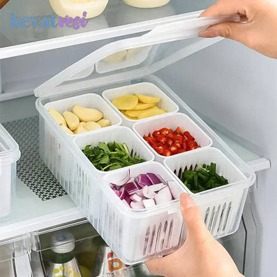 Organized refrigerator storage box with multi-grid design holding fresh vegetables and fruits.