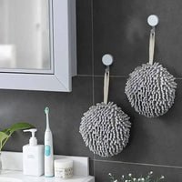 Stylish grey chenille towels hanging in a modern bathroom for quick drying and plush comfort.