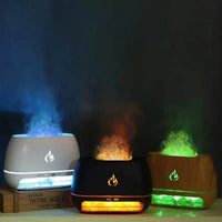 Mini Ultrasonic Flame Aroma Diffuser in white, black, and wood designs with soothing scents and colorful mist.