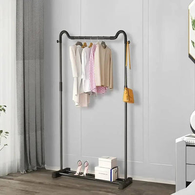 Freestanding black metal garment rack displaying organized clothing in a modern room, enhancing closet space and style.