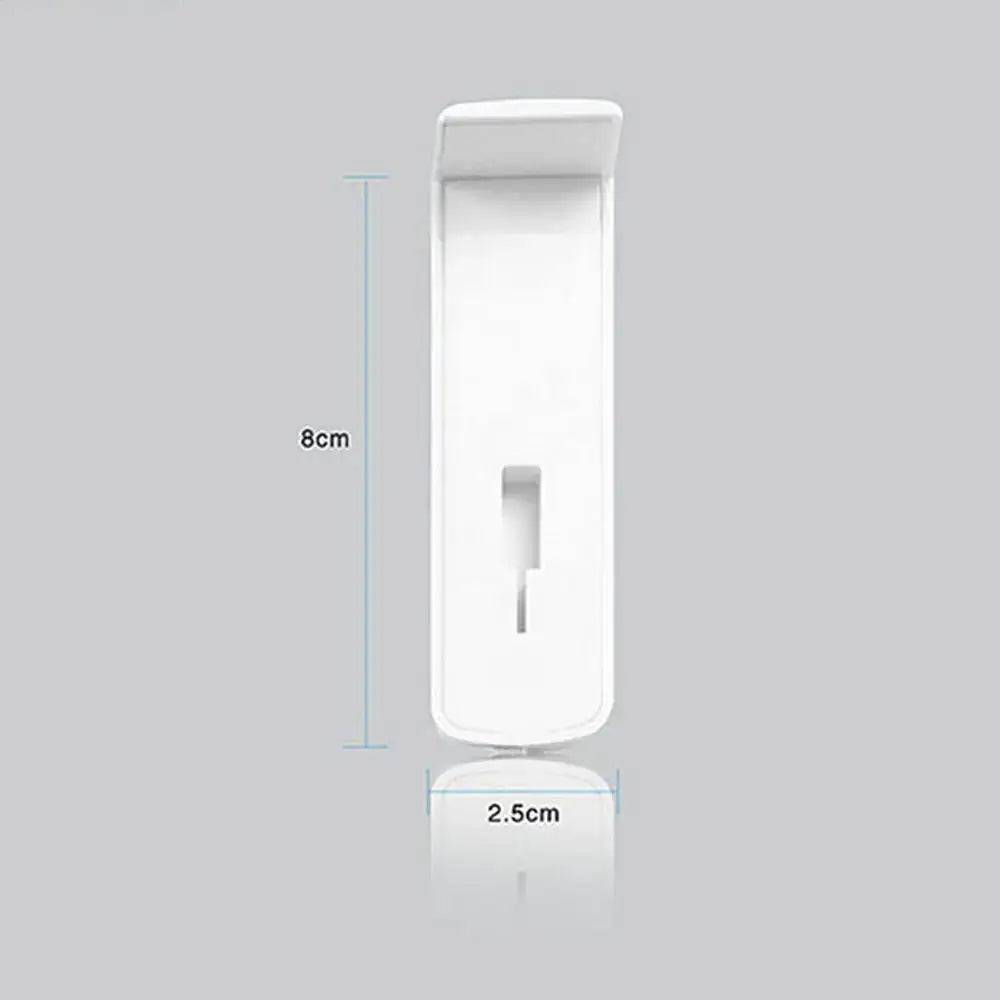 Universal headphone holder made of durable plastic, measuring 8cm by 2.5cm, designed for wall or monitor attachment.