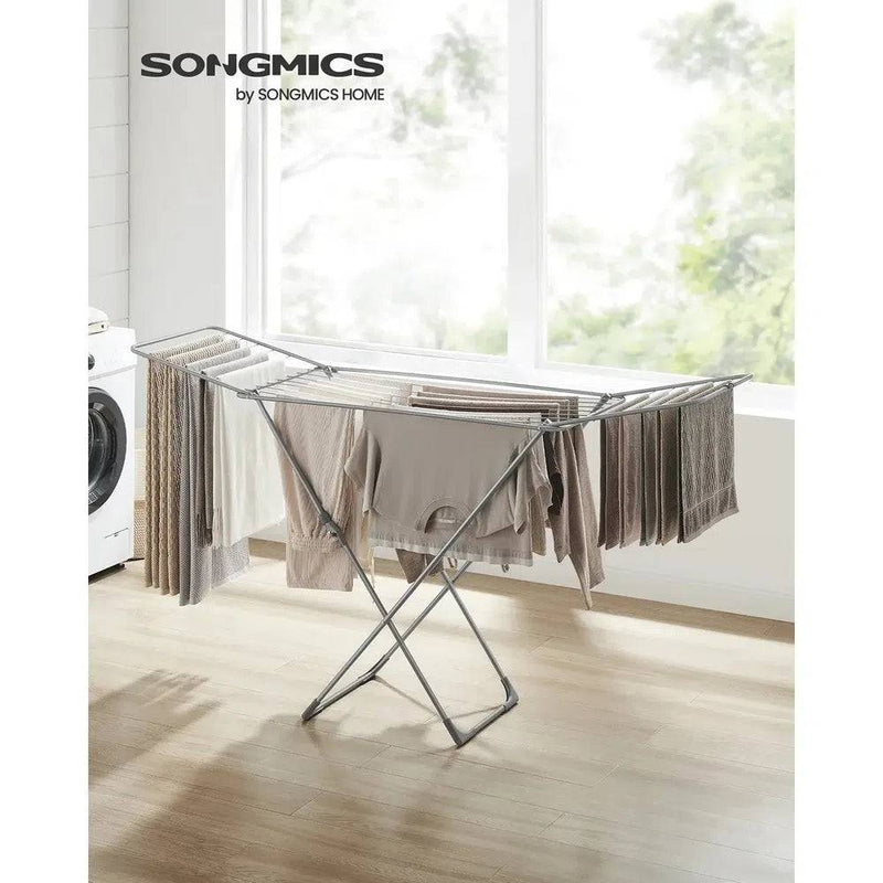 Foldable clothes drying rack with gullwing arms, efficiently drying laundry indoors with ample space.