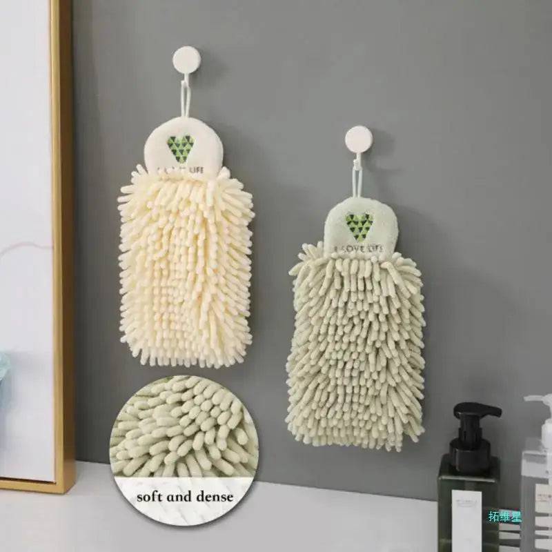 Quick-drying chenille hand towels in soft hues hanging on a wall, showcasing their ultra-absorbent texture and fluffy design.
