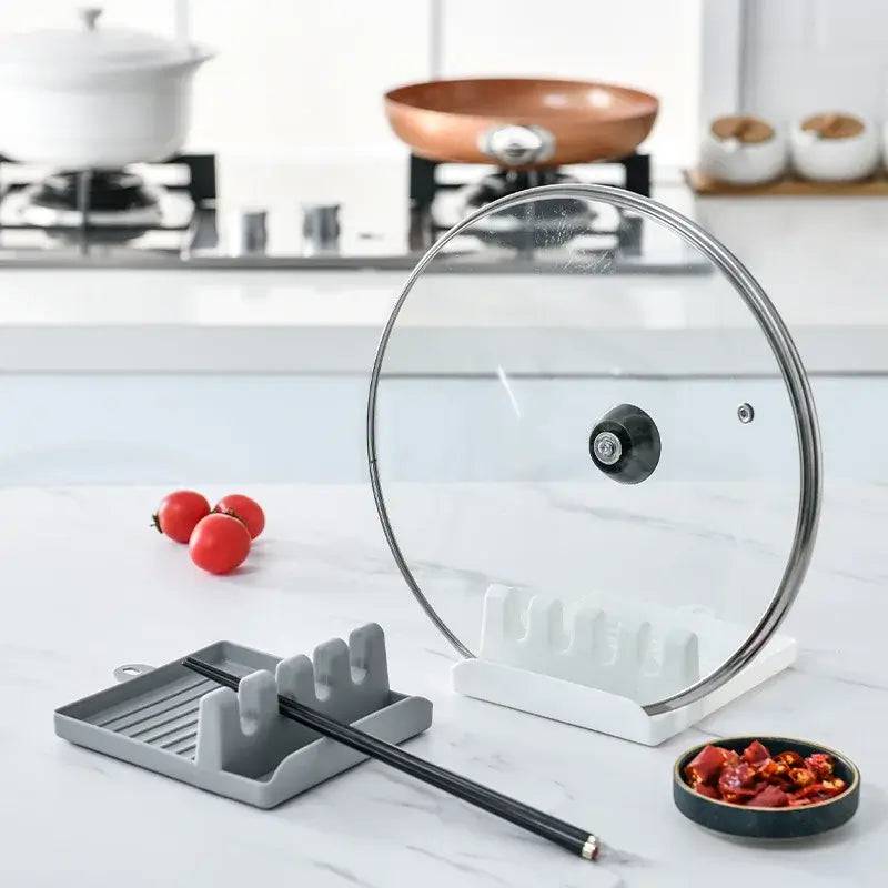 Modern kitchen scene featuring a clear lid holder, chopsticks, and a dish of spices on a clean countertop.