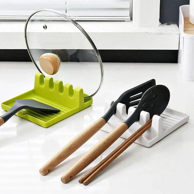 Plastic utensil holder with non-slip base, featuring spatula and spoon, enhancing kitchen organization.