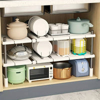 Multi-tier under sink organiser showcasing pots, bowls, a microwave, and cleaning supplies for smart storage solutions.