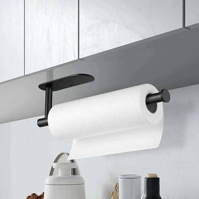 Sleek black wall-mounted paper towel holder with a roll of white paper towels in a modern kitchen setting.