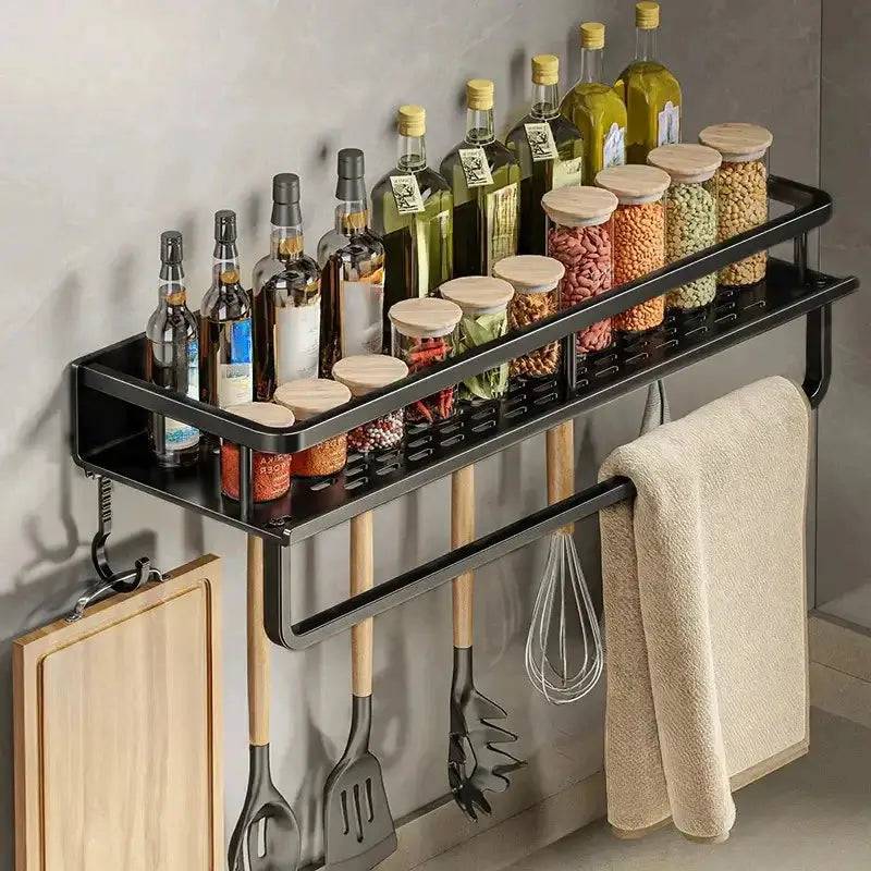 Wall-mounted spice rack with towel bar, featuring jars of spices and cooking oils, enhancing kitchen organization.