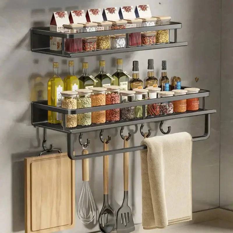Wall-mounted spice rack with towel bar, storage jars, oils, spices, and kitchen utensils for organized cooking.