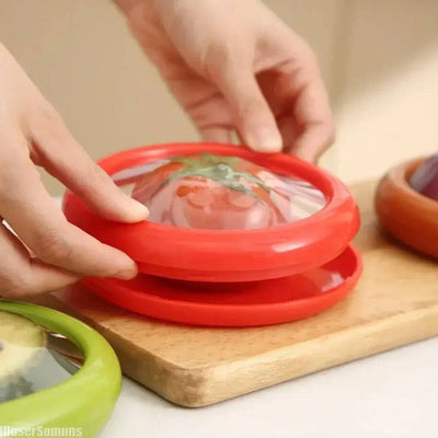 Hands placing red silicone food storage containers on a wooden board, showcasing eco-friendly design to keep produce fresh.