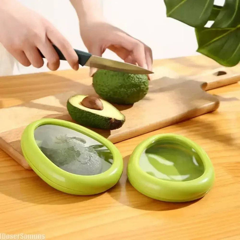 Silicone food storage containers preserving fresh avocado on wooden cutting board in kitchen.