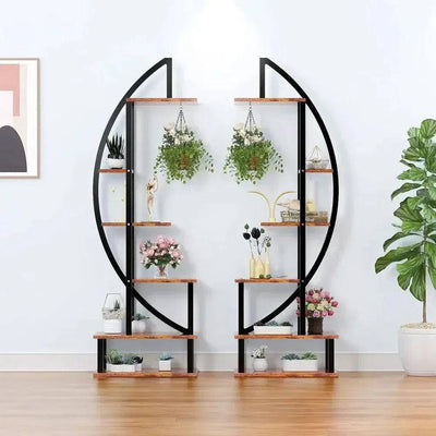 Elegant brown crescent wood tiered plant stand with black metal frame showcasing a variety of plants and decor.