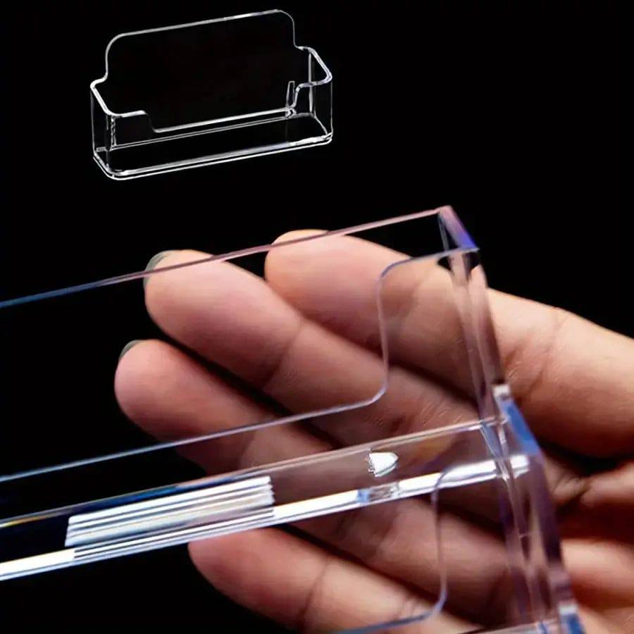 Clear single compartment card holder displayed in a hand, showcasing its sleek design and minimalist style.