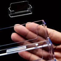 Clear single compartment card holder displayed in a hand, showcasing its sleek design and minimalist style.