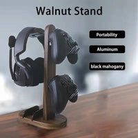 Walnut wood headphone stand with aluminum frame displaying headphones and controllers, highlighting its stylish design.