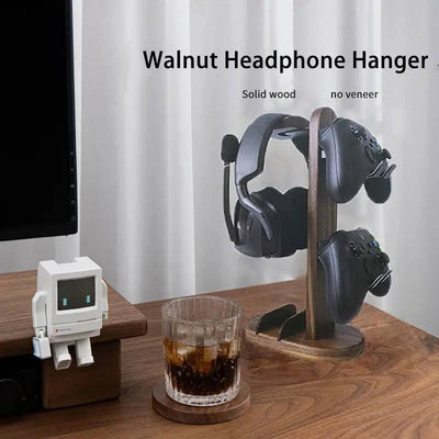 Stylish walnut headphone stand holding a headset and gaming controllers on a wooden desk, perfect for organizing audio gear.
