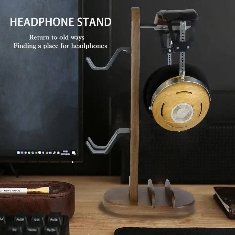Stylish walnut wood headphone stand with aluminum frame, perfect for organizing headphones in a modern workspace.