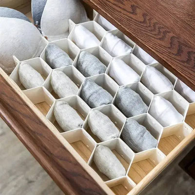 Honeycomb drawer dividers organizing socks and underwear for a tidy and efficient storage solution.