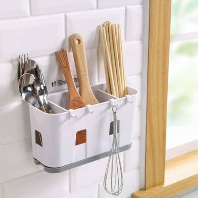 Wall mounted cutlery drainer with drip tray holding utensils for kitchen organization and space-saving.