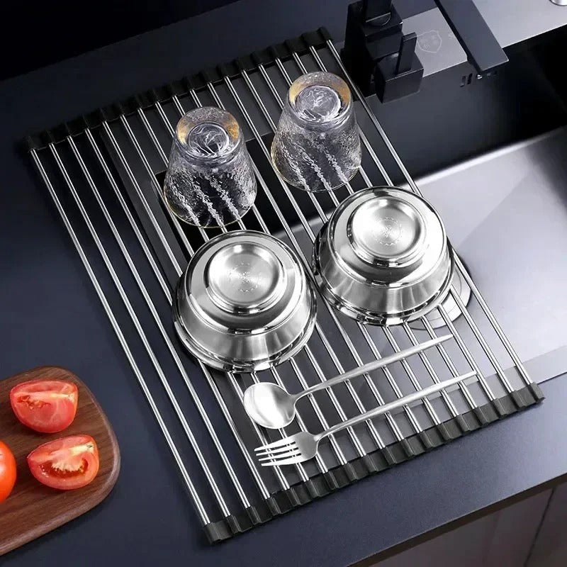 Foldable stainless steel draining rack with dishes, glasses, and utensils for efficient kitchen organization.