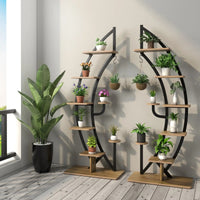 Elegant 6-tier metal plant stand with shelves displaying various potted plants in a stylish indoor setting.