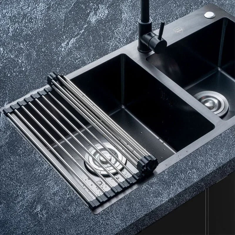 Foldable stainless steel draining rack positioned over a modern kitchen sink, enhancing space-saving kitchen organization.