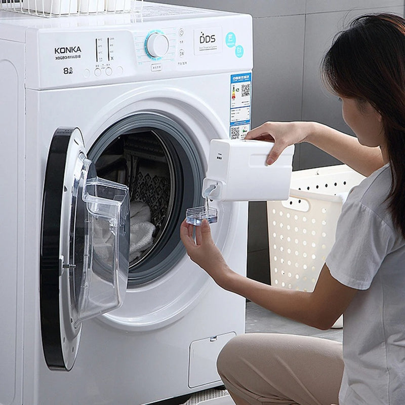 Woman using a reusable eco-friendly laundry detergent bottle at a washing machine.